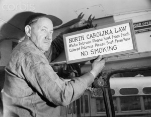 Bus Driver Removing Segregation Sign from Bus